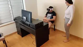 Hot stepmother masturbates next to her son while he watches porn with virtual reality glasses