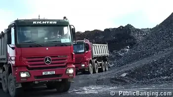 A very cute blonde young lady is fucked in public threesome at a construction site