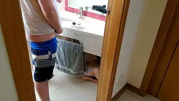 Stepsister receives facial cumshot through a hole in the sink