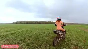Naked woman riding a Dirt Bike