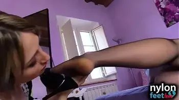 Horny maid in white stockings worships brunette nylon feet