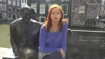Pretty redhead walking naked in Amsterdam