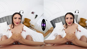 A long-haired brunette with natural tits fucks in missionary position