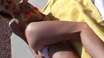 Hot blonde model shows off her body in a bikini in public