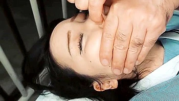 Her breasts are fondled from behind and her cock is thrust deep into her throat.