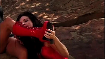 Two ladies red and black in latex are romping, licking and fucking