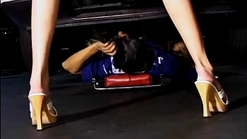 Two service technicians drill pretty brunette in the garage