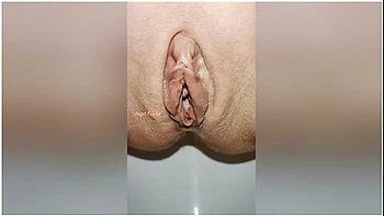 Beautiful Bald Pussy Of Petite Milf Makes The Big Powerful Urine Fountain Close Up