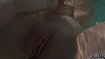 Redhead Lily Mays plays with toys by the pool