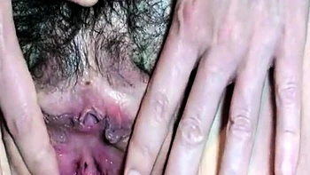 German MILF fingers her hairy pussy at home