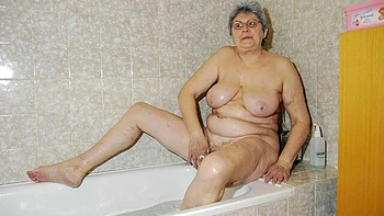 An old lady Gerlinde is touching her shaved pussy in the bathroom