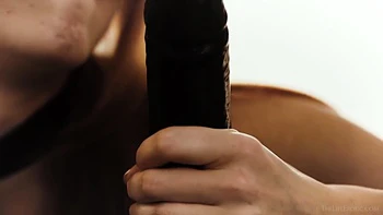 Zorra pelirroja se masturba con un enorme dildo negro en lencería