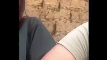 Two lesbians touch each other to orgasm on the corner of a town trying to avoid being seen by anyone