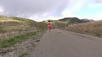 Mature milf with naked charms walks on a public road outdoors. Exhibitionist with a gorgeous ass and hairy pussy. PAWG and amateur fetish.