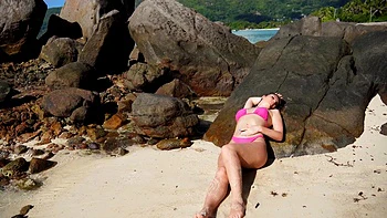 Sizzling Candice flaunts her curves in a skimpy bikini on sunny shores