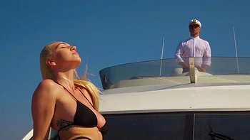 A girl with big boobs is having fun on the beach with her boyfriend.